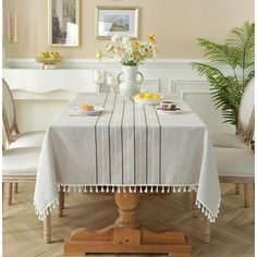 a dining room table covered with a white tablecloth