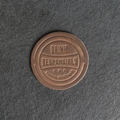 a brown drink responsity coin sitting on top of a table