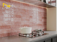 a stove top with pots and pans on it next to a wall that has a yellow arrow pointing up