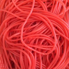 an image of many red cords in the middle of some sort of stringy material