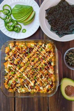 a casserole dish with vegetables and other ingredients on the side, ready to be eaten