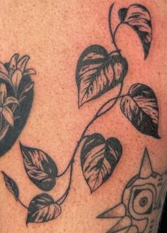 a close up of a person's tattoo with flowers and scissors on his arm