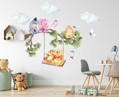 a child's room with winnie the pooh swinger wall decals and toys