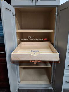 an open cabinet with measurements for the bottom shelf