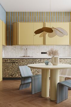 a kitchen with yellow cabinets and chairs around a white table in front of an oven