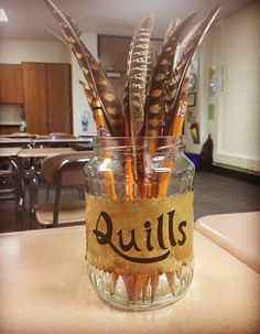 a glass jar filled with lots of writing on top of a table