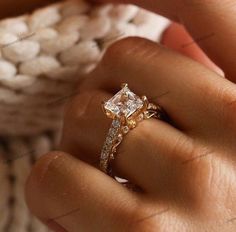 a woman's hand with a ring on it