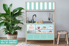 a potted plant sitting next to an ice cream shop counter with cupcakes and pastries on it