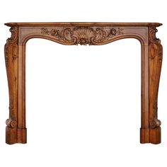 an ornate wooden fireplace mantel with carvings on the top and sides, made from wood