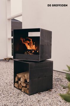 an outdoor fire pit with logs in it