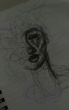 a drawing of a woman's face on a piece of paper