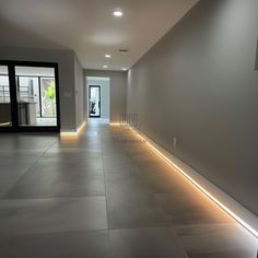 an empty hallway is lit up with leds