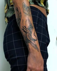 a person with a bird tattoo on their arm