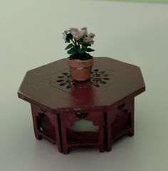 a small potted plant sitting on top of a wooden table