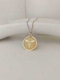 Pendant Material: 14K Solid Real Gold (NOT GOLD PLATED) Hallmark for certification engraved on the back: 585 Pendant Dimensions: - 13mm / 0.51 inches diameter - 15mm / 0.59 inches diameter - 16mm / 0.62 inches diameter - 18mm / 0.70 inches diameter - 20mm / 0.78 inches diameter *Real images of the pendant, size 15mm / 0.59 inches diameter* Thickness: 0.5mm Jump ring inner diameter: 4mm Chain Material: 14K Solid Real Gold (NOT GOLD PLATED) Chain Length available: - No Chain - 35 cm / 13,7 inches Rod Of Asclepius, Caduceus Symbol, Real Images, Nurse Graduation, Medical Alert, Nursing Graduation, Custom Pendants, Gold Price, Sentimental Gifts