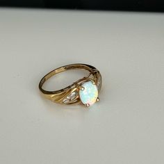 10k Yellow Gold Opal Center Oval Stone With Diamond Accents On The Sides. Size 5 Or 5.5 Opal Ring Gold, Oval Stone, 10k Gold, Opal Rings, Womens Jewelry Rings, Opal, Womens Sizes, Yellow Gold, Women Jewelry