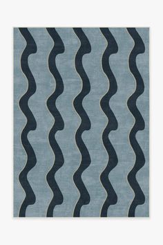 a blue and black rug with wavy lines on it