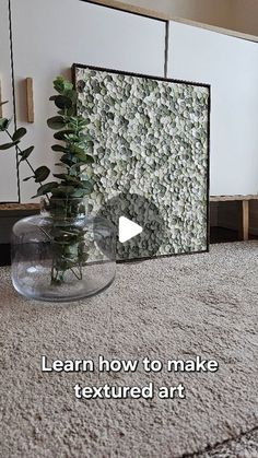 a vase filled with plants sitting on top of a carpeted floor next to a mirror