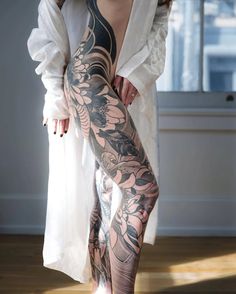 a woman with tattoos on her legs and leggings