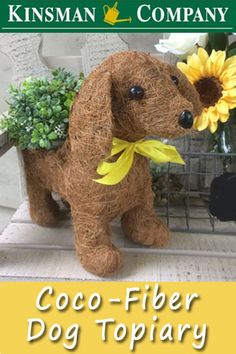 a stuffed dog sitting on top of a chair next to a vase filled with flowers