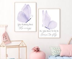 two purple butterflies are hanging on the wall above a blue bed and pink pillows in a girls'bedroom