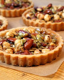 several small pies with nuts on top of them