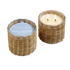 two wicker candles sitting next to each other on a white background, one is blue and the other is brown