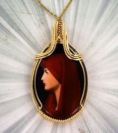 THE BEAUTY OF CAMEOS Amazing   2  inch   hand Painted  cameo  set in  14kt. Rolled Gold   ---- a one of a kind custom design. 40x30mm oval   shaped Cameo  with high detail which cannot be seen in the photograph.  The Cameo -- Intricate detail that you can see and notice The Cameo is  2  INCHES  LONG Very delicate and intricate in appearance and will get you noticed!   One of a kind handcrafted piece of jewelry that anyone will look good in Absolutely amazing something that you will be proud to wear You won't be disappointed with cameo pendant Cameo Jewelry, Saint Joseph, Cameo Necklace, Cameo Pendant, Be Proud, The Photograph, The Beauty, Jewelry Necklaces, Accessory Gift