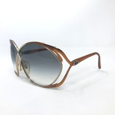 Brand: Christian Dior Model: 2056 44 Colour: Gold and brown. See photos for colour, pattern and detailing Rim Type: Full rim Gender: Women Frame Material: Metal & Plastic Lens Width: 66 mm *please note this is an approximate measurement as it has been hand measured Bridge: 20 mm *please note this is an approximate measurement as it has been hand measured Temple/Arms: 110 mm  See photos for frame width and lens height Condition: These are wonderful vintage sunglasses, they have been previously us Dior Model, Vintage Christian Dior, Colour Pattern, Vintage Sunglasses, Gold Sunglasses, Sun Shade, Sunglasses Vintage, Vintage Frames, Eyewear Sunglasses