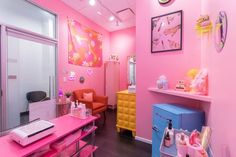 a pink room with lots of furniture and decor on the walls, along with other items