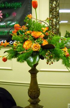 a vase filled with flowers sitting on top of a table