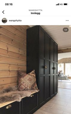 a room that has some black cabinets and pillows on the shelf in front of it