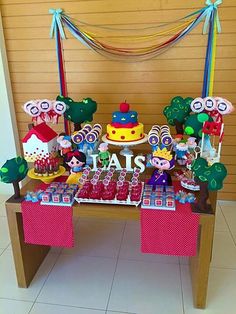 a table topped with lots of cakes and desserts