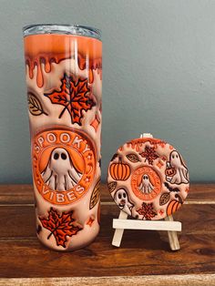 a halloween themed tumbler next to a cookie