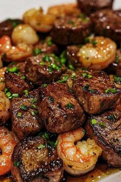 a white plate topped with steak and shrimp