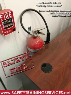 there is a fire extinguisher on the wall next to a sign that says safety fail