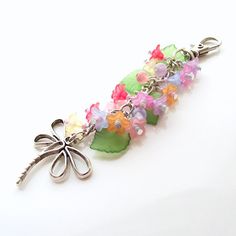 a bunch of flowers that are sitting on a keychain with a flower attached to it