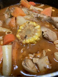 a stew with carrots, corn and potatoes