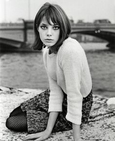 black and white photograph of a woman sitting on the ground