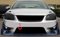 the front end of a white car with an arrow pointing to it's left