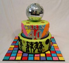 there is a cake that has been decorated with disco balls and the number 40 on it