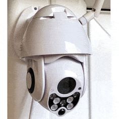 a white camera mounted to the side of a wall