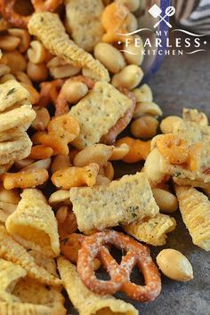 cheesy snack mix with pretzels and crackers in the middle on a table