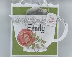 a close up of a card with a coffee cup on it and a tag hanging from the front