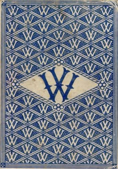 an old blue and white tile with the letter w on it