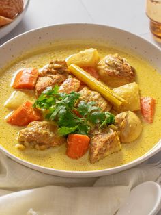 a white bowl filled with meat and vegetables