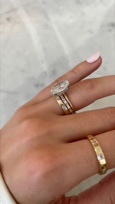 a woman's hand with two different rings on her left and the other half of her finger