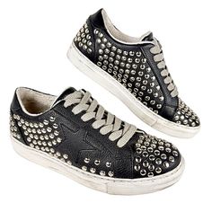 Keep your style phunky fresh from head to toe in this fashion-forward studded lace-up sneaker. Bumper toe, gray laces, synthetic upper, silver-toned metallic studded embellishments, plush fabric sock lining, rubber sole. Pre-owned condition: good. Only visible signs of wear are in the sock lining and soles. Outer material (visible portion of shoes) is in excellent shape. Lots of life left in these funky punk-rock shoes! Studded Sneakers, Embellished Shoes, Sneakers Womens, Plush Fabric, Punk Rock, Flat Shoes Women, Steve Madden, Shoes Flats, Rubber Sole