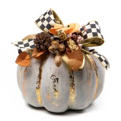 a decorative pumpkin decorated with flowers and leaves