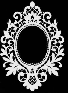 a black and white photo with an ornate design in the center, on top of a ruler